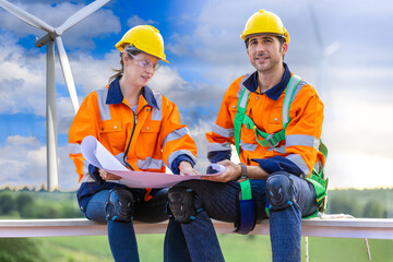 Engineer team man and woman working together survey plan construction wind turbine sustainable...