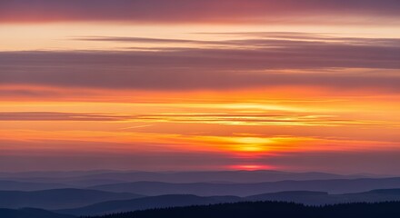 Vibrant Sunset Over Mountain Ranges with Colorful Sky and Atmospheric Perspective