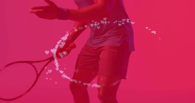 Male athlete releasing tennis ball initiating heart animation circling waist for sports marketing