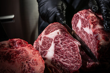 Butcher expertly cutting a marbled raw steak