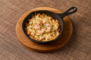 Cheesy Shrimp Baked Rice in Mini Skillet on Wooden Board