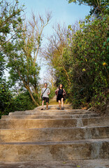 Tourist is descending the stairs to Green Bowl Beach in Bali, Indonesia.