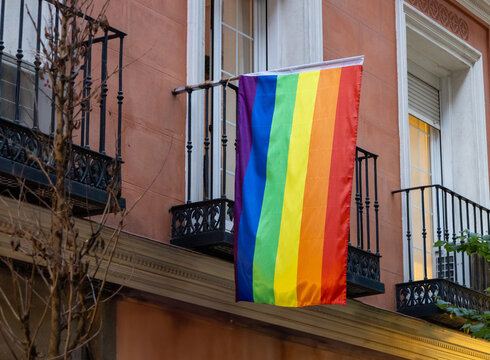 Rainbow flag hanging from a balcony.