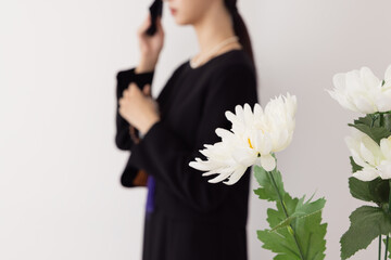 お葬式イメージ　涙をハンカチで拭く女性
