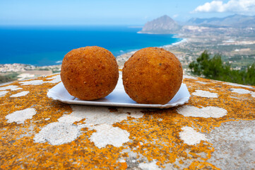 Arancini Sicilian, deep-fried rice balls made with risotto, filled with ingredients mozzarella,...