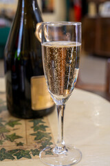 Pouring and tasting of dry sparkling wine brut, grand reserve, champagne in Ay-Champagne wine making village in Vallee de la Marne, , Champagne region, France