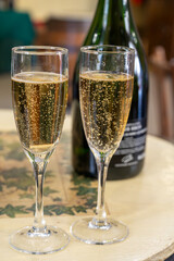 Pouring and tasting of dry sparkling wine brut, grand reserve, champagne in Ay-Champagne wine making village in Vallee de la Marne, , Champagne region, France