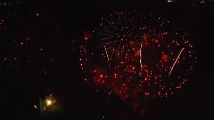 Spectacular aerial footage capturing vibrant fireworks display at night celebration - Powered by Adobe