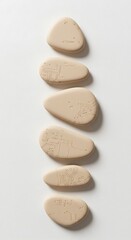 Abstract Beige Stones Arranged Vertically on White Background