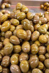 Homemade italian pickled green olives with garlic and spices on food market in Palermo, Sicily, italy
