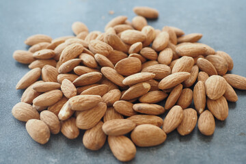 Freshly harvested almonds displayed on a rustic surface