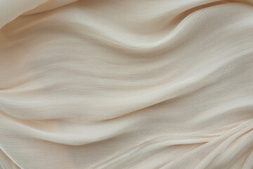 Soft beige fabric flowing gently with elegant texture