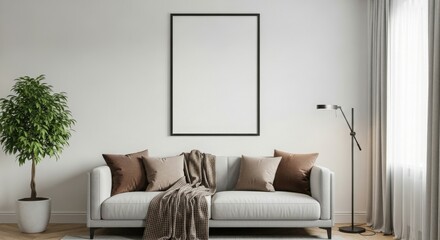 A modern living room featuring a sofa, decorative pillows, a plant, and a blank wall for art.