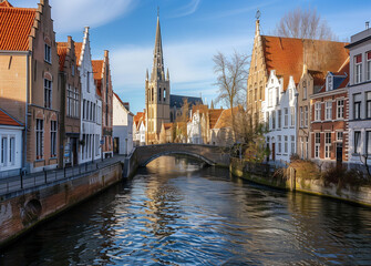  Gothic church and historic town houses with canal under blue sky