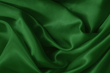 Obraz premium Dark green fabric cloth texture for background and design art work, beautiful crumpled pattern of silk or linen.