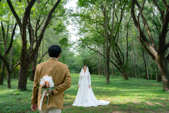 bride and groom walking in the park