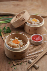 Dumplings on wooden plate and wooden table