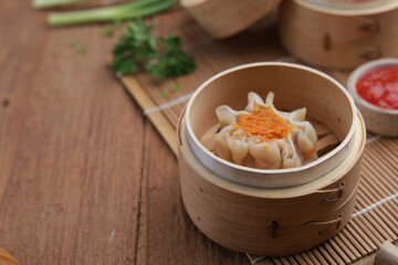 Dumplings on wooden plate and wooden table