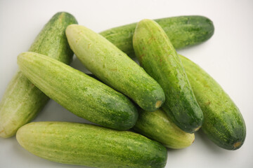 Piled of cucumbers on white background
