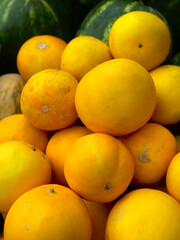 Lots of yellow ripe melons as background, top view