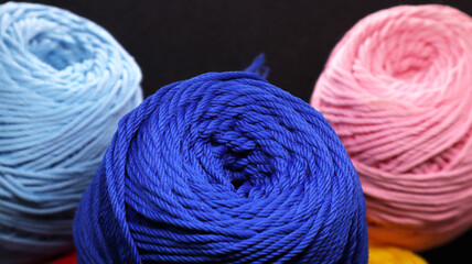 Colorful threads for crochet on black background