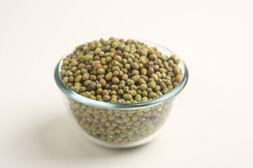Mung beans in transparent bowl on white background