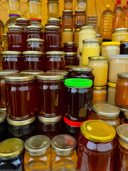 Honey store counter top full of types of honey jars in different colors with copy space for mockup