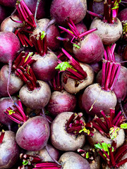 A pile of fresh organic beets at a local produce market.