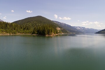 Calm river and mountains against sky