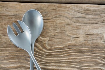 Spoon and fork on wooden table © vectorfusionart
