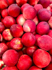 Full screen background of bright and ripe nectarines. Harvest concept.