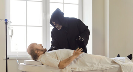 Senior man patient in clinic fears visit from grim reaper, facing illness and death, focusing on...