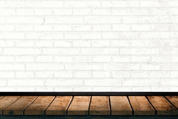 Rustic wooden plank tabletop is being showcased in flat design studio with white painted brick wall
