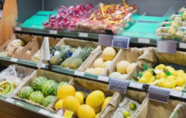 Defocused image of fruits arranged in crate at marke