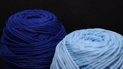 Colorful threads for crochet on black background