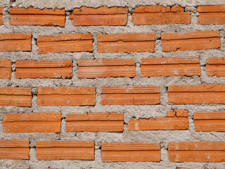 Old red brick wall texture vintage background, rustic urban exterior.