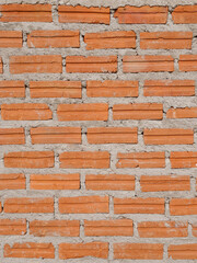 Old red brick wall texture vintage vertical background, rustic urban exterior.