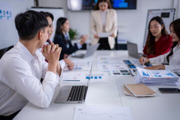 Business team analyzing financial data and discussing growth strategies in a meeting