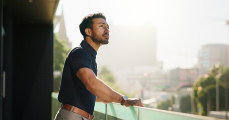 Urban, balcony or businessman at office thinking of ideas for daydreaming, vision or reflection. Developer, realtor or real estate agent with city view, mission or inspiration for property investment © peopleimages.com
