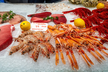 Different kinds of shrimps, prawns and tuna fillet for sale at a market in Barcelona, Spain