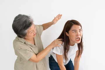 Asian Thai elderly woman hitting and lecturing granddaughter react funny dramatically, isolated over white wall.