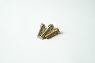 Three golden metal bolts arranged on a clean white background. Industrial hardware for construction, repair, or mechanical use. 
