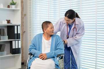 Obraz premium Doctor gently touching shoulder of older woman in wheelchair, expressing support, encouragement, and compassionate communication in warm indoor setting, healthcare, check. medical, examination.