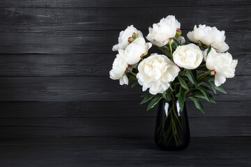 Bouquet of white peonies on black table background..