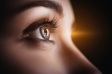 Piercing blue female eyes close up background...