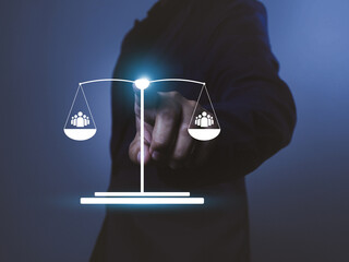 Businessman pointing at digital scale with people icons, concept of social balance and equality,...