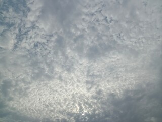selective image of cloudy sky. Stormy dark sky. Dark storm clouds in the evening spring Sun shinning behind the clouds