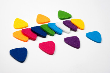 Felt picks in different colors for playing the ukulele or other string instruments.