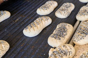 Freshly baked bread rolls cooling at a busy bakery plant in the early morning hours