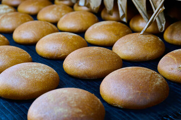 Freshly baked white-rye blend and Baltic rye bread cooling at a bakery oven outlet in a charming...